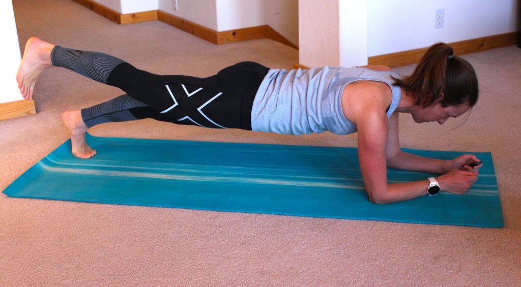 A person doing the plank with one leg extended