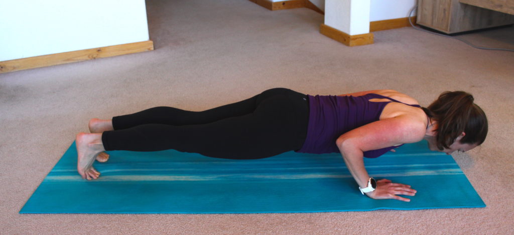 A woman demonstrating a push up