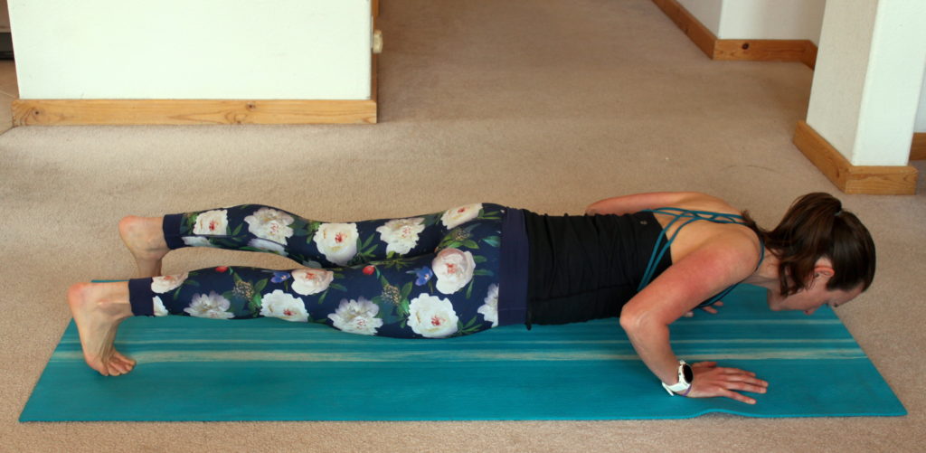 A woman demonstrating a proper push-up