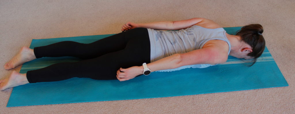 A woman demonstrating a preparation exercise for a push up